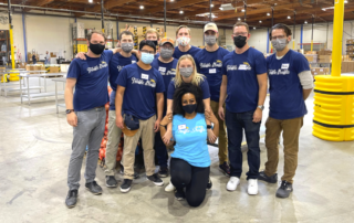 Jason (left) with the Truffle Shuffle team volunteering at the Food Bank's Community Engagement Center
