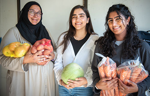 Aminah, left, with volunteers Maleeha and Farrah