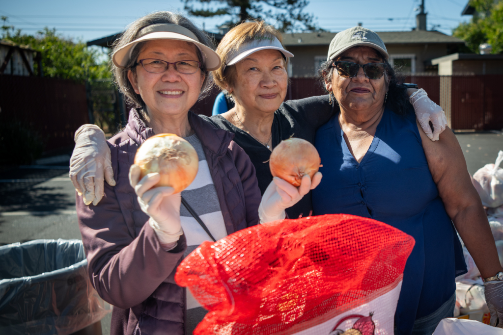 Volunteers holding grapefruits at Shiloh Mercy House
