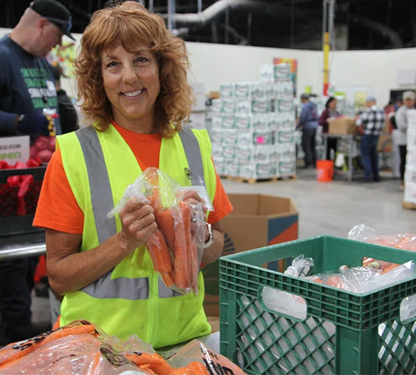 Quote-image-600×540-Audrie Person standing behind bins of fresh produce (placeholder — replace per instance)